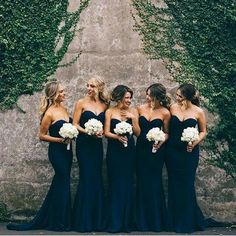 the bridesmaids are all dressed in navy blue dresses