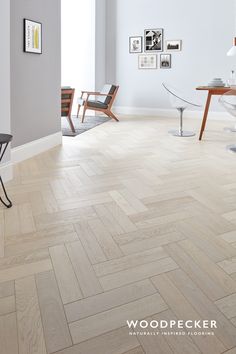 an image of a room with wood flooring on the walls and pictures on the wall