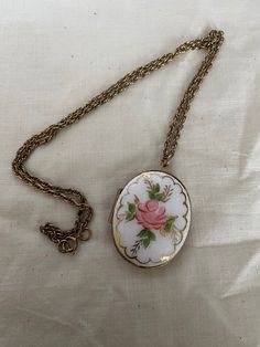 This is a vintage handpainted enamel locket. It is on a 24 inch chain and is in good vintage condition. Measurements of locket are in picture. Oval Enamel Locket Necklace, Oval Locket Necklace In Enamel, Antique Enamel Locket Necklace, Victorian Enamel Medallion Necklaces, Vintage Enamel Round Pendant Necklace, Vintage Enamel Round Pendant Jewelry, Vintage Enamel Necklace With Round Pendant, Vintage Cameo Jewelry In Enamel, Vintage Cameo Enamel Jewelry