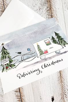 an envelope with a christmas card on the front and bottom that says, delivering christmas