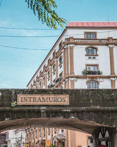 the entrance to an old building with a sign above it that says intramuros