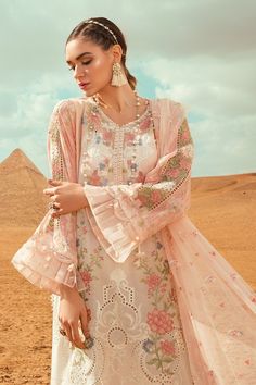 The new party and festive wear collection is all set to grab your attention with Pakistani designer eid dresses. You can buy lavish fancy wear online to adorn your special event look in an elegant way. Shirt: This lavish festive attire is showing its grace with elegant white color embroidered panels for shirt. Lawn shirt is embellished with embroidered front and printed back panel. Neck is designed with lawn embroidered neckline. Lawn sleeves are designed with beautiful prints. Shirt has beautif Eid Outfits Pakistani, Eid Dresses Pakistani, Eid Dresses For Girl, Maria B Lawn, Dresses Pakistani, Lawn Dresses, Dress Pakistani, Eid Dress, Designer Summer Dresses