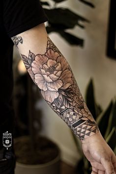 a person with a flower tattoo on their arm