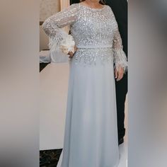 My Mom Wore This Dress For My Wedding In August. Beautiful Color And Looks Elegant For A Special Occasion. Only Alterations She Did Was To Shorten The Bottom A Bit. Wore Only Once, Like Brand New. No Stains! Elegant Embellished Dresses For Mother Of The Bride, Long Sleeve Embellished Mother Of The Bride Dress, Elegant Embellished Mother Of The Bride Dress For Wedding, Elegant Long Sleeve Embellished Wedding Dress, Elegant Silver Mother Of The Bride Dress, Elegant Silver Mother Of The Bride Dress For Wedding, Silver Long Sleeve Dress For Banquet, Embellished Mother Of The Bride Dress For Wedding, Elegant Silver Mother Of The Bride Dress For Banquet