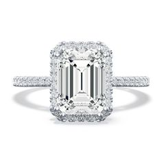 an emerald cut diamond ring with diamonds around it