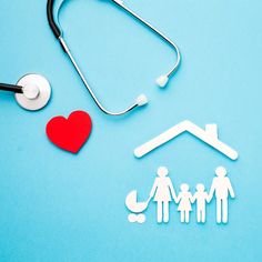 a stethoscope, paper cutout of a family and a doctor's stethoscope on a blue background