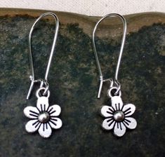 "These are just so sweet and cute! Little daisy dangle earrings. Perfect addition to any outfit and sure to brighten your day! Made from allergy free plated silver. The flowers measure 1/2\" long by 3/8\" wide and hang from 1\" kidney style ear wires that lock and latch. Overall drop length is 1 1/2\". Thanks for stopping by! Please take a moment and visit the rest of my Etsy shop. I have many more unique jewelry designs to choose from! 🌸 Tiger Flower Jewelry 🌸 🌸 Inspired by Nature 🌸" Tiger Flower, Flower Earrings Silver, Small Flower Earrings, Vintage Drop Earrings, Daisy Pendant, Daisy Jewelry, Silver Flower Earrings, Daisy Earrings, Unique Jewelry Designs