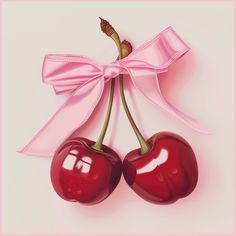 two cherries tied to a pink ribbon with a bow on it's end