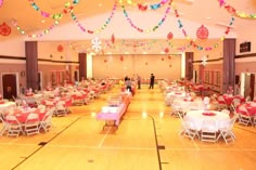 an indoor banquet hall with tables and chairs set up for a party or celebration,