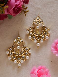 Add a touch of timeless elegance to your jewelry collection with these beautifully crafted golden kundan earrings lined with small jhumkas.  Designed with intricate details and high-quality materials, these earrings are the perfect accessory to elevate any outfit, whether it's for a special occasion or adding some glamour to your everyday look. The stunning golden color of these earrings makes them versatile and easy to pair with any outfit. The intricate design of the kundan setting adds a touc Small Kundan Earrings, Elegant Kundan Jhumkas With Gota Work, Festive Yellow Gold Kundan Pearl Earrings, Gold Kundan Danglers For Gift, Gold Kundan Earrings With Cutdana, Festive Kundan Bridal Earrings With Mirror Work, Gold Kundan Chandbalis In Temple Jewelry Style, Gold Kundan Chandbalis With Mirror Work, Gold Jhumkas With Mirror Work For Eid