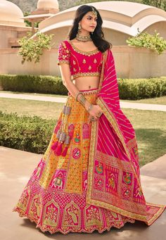 Yellow banarasi silk embroidered lehenga choli 10119  Desc:  Style : Circular Lehenga Choli Color : Yellow   Pink Fabric : Banarasi Silk Work : Embroidery Occasion : Wedding   Mehendi   Sangeet   Reception   Lohri   Teej   Gudi Padwa Wash Care : Dry clean Sleeve Style : Half Sleeve Long Sleeves : Done only in Custom Stitch Sleeves Lining : Done only in Custom Stitch Bust Size: 32 to 42 Inches. With Express Free Shipping and Custom Stitching, Buy Indian Wedding Party Wear lehenga Yellow banarasi Fancy Lehenga, Haldi Outfits, Banarasi Lehenga, Lehenga Design, Raw Silk Lehenga, Yellow Lehenga, Lehenga Online, Regal Design, Lehenga Choli Online