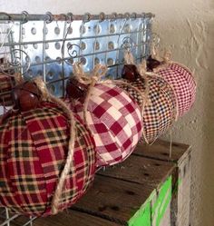 three plaid ornaments are hanging on a wire rack