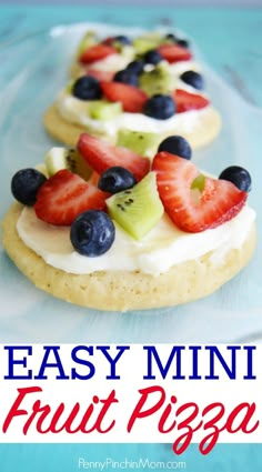 three small pastries with fruit on them are sitting on a white plate, ready to be eaten