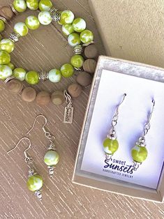 Key Lime Bead Drop Earrings - Dangle bead earrings made with large, swirled lime green and bright white polished stone beads, small silver accents beads, and NICKEL FREE - 925 Sterling Silver earring hooks.  Colorful, vivid and fun drop earrings! These handmade earrings will add a colorful pop of lime green to liven up your look!  This listing is for ONE set of earrings. The bead drop earrings look great with coordinating stretch bracelets, made with the same lime and green swirl beads:  https://www.etsy.com/listing/1750426888/key-lime-beaded-bracelets-lime-green-and See other fun stretch bracelets and jewelry items at our shop: https://sweetsunsetsjewelry.etsy.com SIZE The drop earrings dangle down 1.75 inches (4.5 cm) from the earring hole, where the earrings hook through the earlobe, do Bead Drop Earrings, Earring Hole, Bead Earring, Handmade Earring, Handcrafted Bracelets, Beaded Drop Earrings, Key Lime, Earring Hooks, Silver Earring