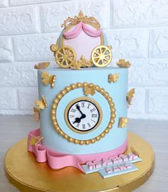 a blue cake with gold trim and a clock on the top that says happy birthday