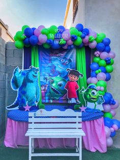 an entrance decorated with balloons and decorations for a children's birthday party in the shape of monsters