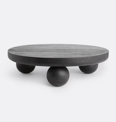 a round table with two black balls on it