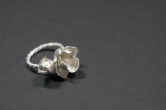 -Product description- Handmade sterling silver (925) jasmine ring. The ring shank is handmade with twisted and beaded wire. The inner surface of the jasmine petal was carefully hand textured to be shimmery. While the outer layer was smooth and shiny, to give a beautiful contrast. A freshwater pearl was then attached to give an elegant touch. Great as a gift for her, or a treat for yourself. The jasmine blossom and bud part are about 25mm in length (1 inch) and 17mm (11/16 inch) in width, weighin Elegant Adjustable Sterling Silver Flower Ring, Elegant Handmade White Gold Flower Ring, Handmade Delicate Silver Flower Ring, Delicate Handmade Silver Flower Ring, Delicate Silver Pearl Ring Gift, Handmade Elegant Silver Flower Ring, Silver Delicate Flower Shaped Ring, Adjustable Delicate Silver Pearl Ring, Delicate Silver Flower-shaped Ring