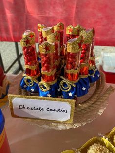 a table topped with lots of candy and candies in plastic containers on top of a plate