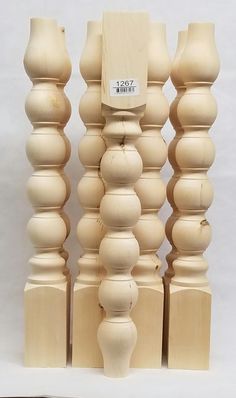 a group of wooden sculptures sitting next to each other on top of a white surface