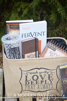 a book bag filled with books sitting on top of a wooden table next to a tree