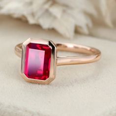 Experience the radiance of red with our Emerald Cut Lab Grown Ruby Engagement Ring in rose gold, a perfect solitaire choice for July birthstone enthusiasts. Engagement Ring Rose Gold, Ruby Engagement Ring, Rose Engagement Ring, Ring Rose Gold, July Birthstone, Affordable Jewelry, Rose Gold Engagement Ring, Lab Diamonds, Bezel Setting