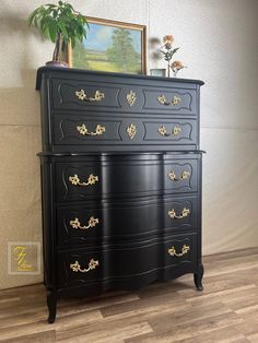 a black dresser with gold handles and drawers