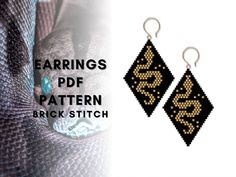 the earrings are made out of black and gold seed beads with an intricate design on them