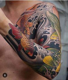 a man with a tattoo on his arm and chest is holding a fish in the water