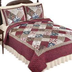 a bed with a red and white quilt on it