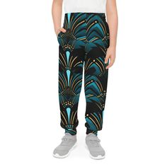 Product Description: Elevate your teen's streetwear game with ourZanzibar Blue & Ebony Black Fashion For Kids Joggers, a versatile addition to their wardrobe that's perfect for various occasions. Whether they're playing sports, lounging at home, or aiming to complete a fresh streetwear look, these joggers have got them covered. Crafted from 95% recycled polyester and 5% spandex, these joggers offer both sustainability and comfort. The medium fabric weight (7.5 oz /yd² (250 g/m²)) strikes the per Blue Fitted Sweatpants For Streetwear, Fitted Blue Sweatpants For Streetwear, Teen Streetwear, Fashion For Kids, Kids Jogger, Playing Sports, Black F, Ankara Print, African Ankara