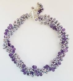 "Exquisite necklace will not disappoint. It is a one of a kind statement piece of jewelry, an investment. Made with beautiful Amethyst, Fresh Water Pearls and using the famous Austrian Crystals and topped off with 925 Sterling Silver. This is a handmade piece. This piece is large. It is 16.5 to 17.5\" long and has a bar clasp.  The faceted natural amethyst drops, pearl and Austrian Crystal wrap is 1.5\" - 2\" Thick." Luxury Handmade Purple Necklace, Silver Single Strand Amethyst Necklace, Silver Amethyst Single Strand Necklace, Silver Amethyst Necklace With Single Strand, Crystal Wrap, Fresh Water Pearl, Austrian Crystal, Collar Necklace, Pandora Charm Bracelet