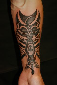 A forearm with a detailed tribal tattoo design. Africa Tattoos