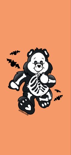 a black and white teddy bear with bats on an orange background