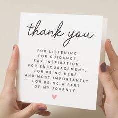 someone holding up a thank card with the words, thank you