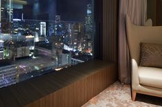 a room with a view of the city at night