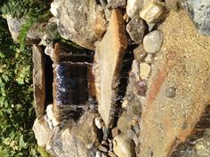 a small waterfall in the middle of some rocks