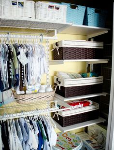 an organized closet with baby clothes, diapers and other items in baskets on the shelves