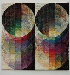 an art work with multiple colors and shapes on the wall, including circles in different sizes