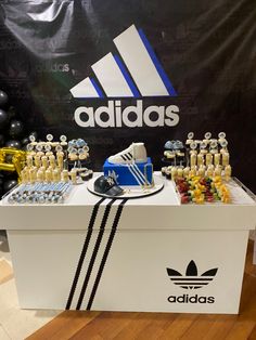 a display table with adidas shoes and other items