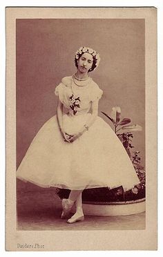 an old photo of a woman in a white dress