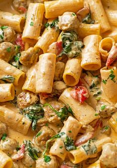 pasta with chicken and spinach sauce in a pan