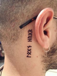 a man with a tattoo on his neck has the word xxvi written in roman numerals