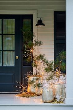 the front door is decorated with pine cones and lights