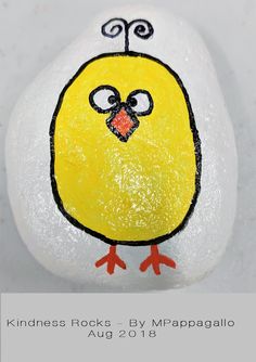 a rock with a yellow bird painted on it