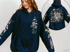 ❤️ Watercolor dried, pressed wildflowers hoodie sweatshirt is a CocoBear original ❤️ Feminine, delicate botanical design featuring spring-blooming violets, buttercups, yarrow, clover, pink baby's breath, and grasses adorns the front, back, and both sleeves. ❤️ Super-soft & cozy with a vintage look and feel. ❤️To ensure sizing, refer to size chart in photos and compare measurements to those of a hoodie sweatshirt you already own that fits well. ❤️ Cotton/poly blend. ❤️ Non-toxic, eco-friendly, wa Long Sleeve Floral Print Hoodie For Fall, Spring Embroidered Hoodie Sweatshirt, Hooded Hoodie With Floral Embroidery For Spring, Floral Print Hoodie Sweatshirt For Spring, Floral Embroidery Long Sleeve Hoodie For Fall, Spring Long Sleeve Botanical Sweatshirt, Pressed Wildflowers, Cottagecore Pastel, Pastel Botanical