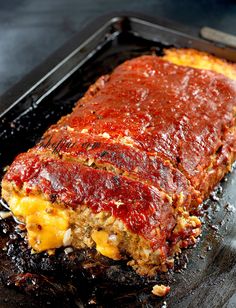 the meatloaf is covered with sauce and cheese