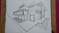 a drawing of a house on top of a piece of paper