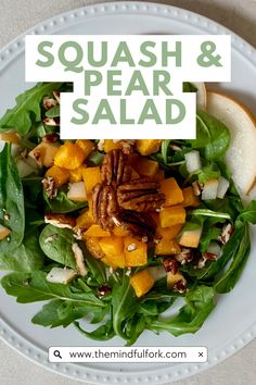 a white plate topped with spinach and squash salad