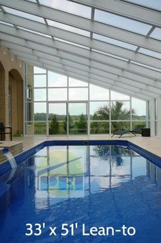 a large indoor swimming pool with glass walls